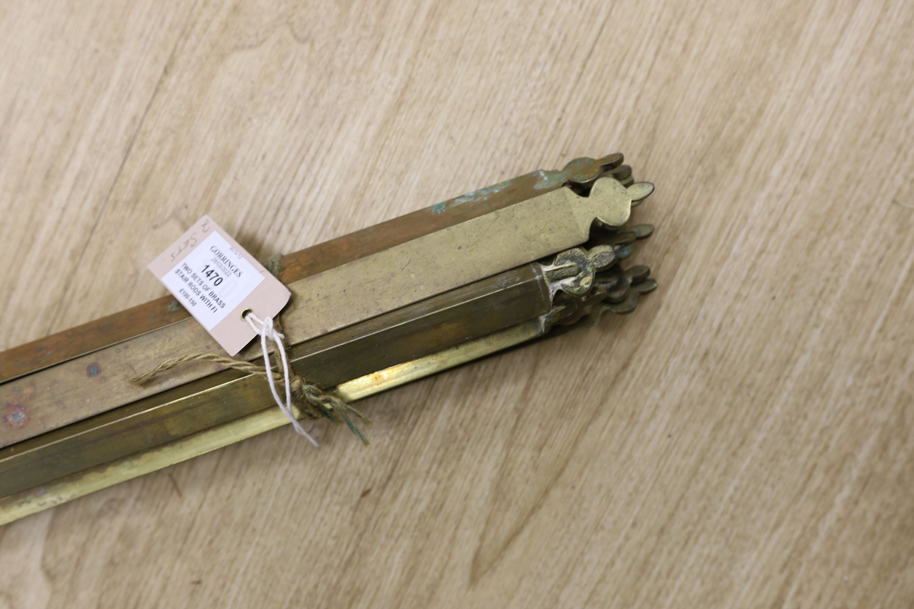Two sets of brass stair rods with fittings.